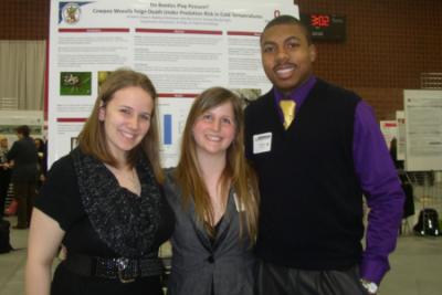 Brittany Coovert, Madison Stuhlreyer, and Kyle Ball in front of research poster at Denman